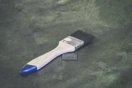 White paint brush on the gray-black cement floorの写真素材