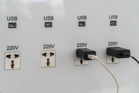 USB slot is attached to the wall for charging.の写真素材