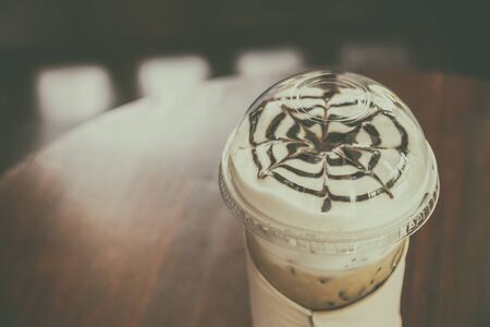 Ice coffee on old wooden table.の写真素材
