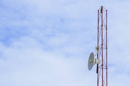 Mobile phone communication tower transmission  signal with blue sky background and antenna