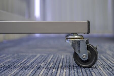 Small black rubber wheel on the carpet.Office abstract backgroundの写真素材