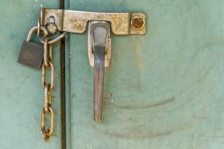 Padlock with rusty chains and green  background vintage styleの写真素材