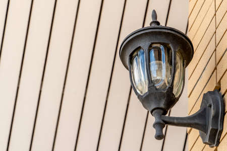 The lampblack stick on the cream wall outdoorの写真素材
