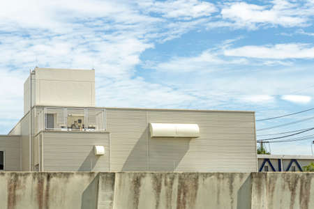 Several white ventilation vents are located next to the building.の写真素材