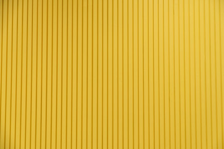 Aluminium dark yellow  list with metal sheet fence.の写真素材