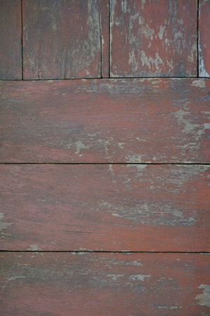An old red wooden floor with dirt stains serves as a background.の写真素材