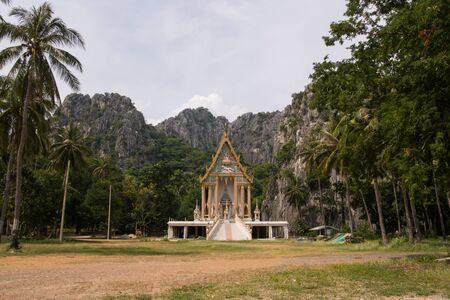 Temple in Thailand behind the mountainの写真素材