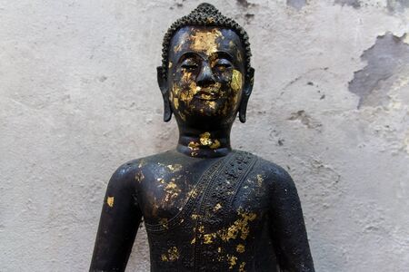Old black ancient Buddha statue の写真素材
