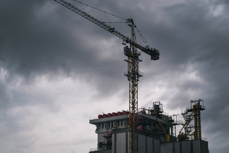 Silhouette of the construction site on sunset backgroundの写真素材