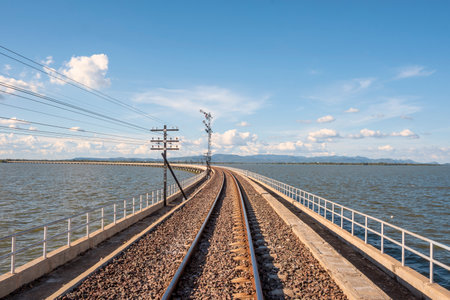 railroad crossing the river of Thailandの写真素材
