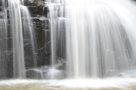 part of a waterfall taken with a slow shutter speed to smooth the waterの写真素材