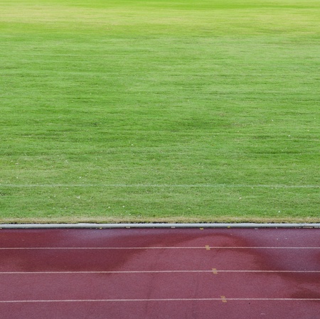 Abstract View Of Running Track And Green Fieldの写真素材