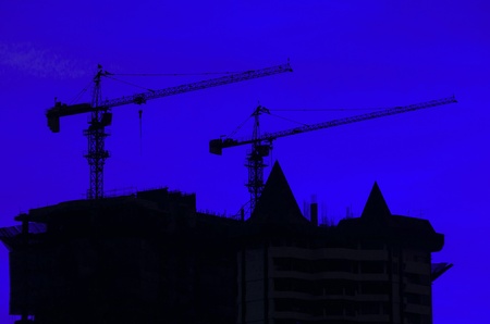 Twilight over the construction craneの写真素材