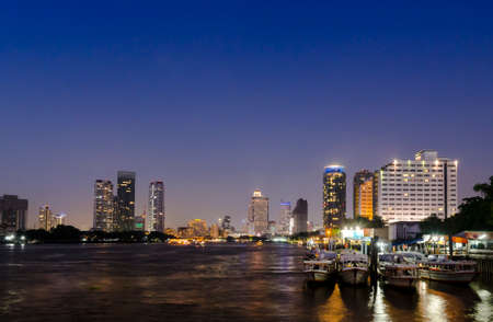 river Mae Nam Chao Phraya in Bangkok with panorama and skyscraper twilightのeditorial素材