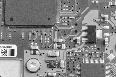 Closeup of electronic circuit board with processor in black and white