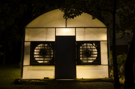 research greenhouse at university campus with lights on at duskの写真素材