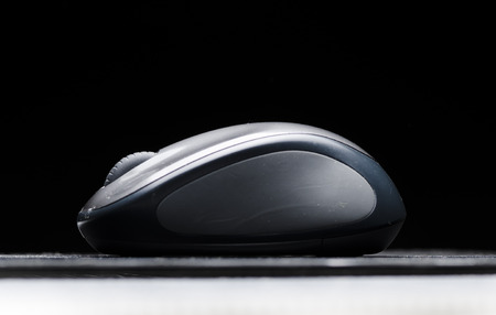 Wireless computer mouse isolated on black backgroundの写真素材
