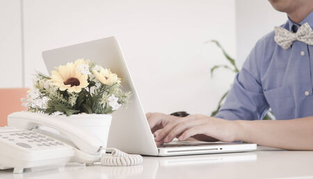 businessman typing on laptop in an officeの写真素材