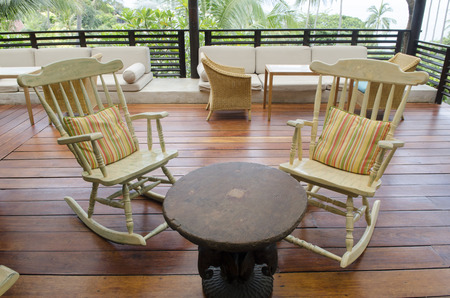 group of relaxing rocking chairs overlooking peaceful mountain view on porch of luxury resort hotelのeditorial素材