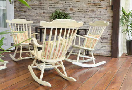 group of relaxing rocking chairs overlooking peaceful mountain view on porch of luxury resort hotelのeditorial素材