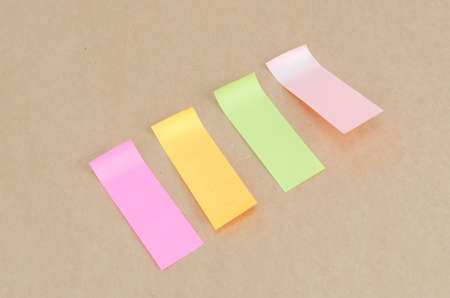 sticky note on brown backgroundの写真素材