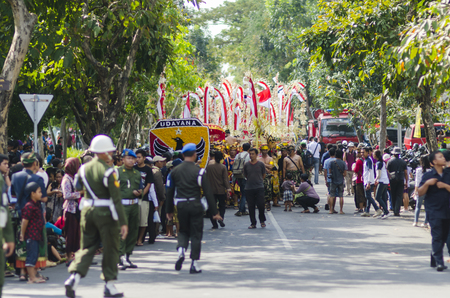 DENPASAR, BALI, INDONESIA - JUNE 18: Unidentified dancer of Balinese in colorful dresses variety on the parade at Bali Art Festival on June 18, 2014 in Denpasar, Indonesiaのeditorial素材