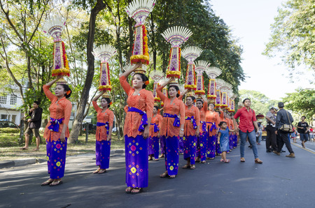 DENPASAR, BALI, INDONESIA - JUNE 18: Unidentified dancer of Balinese in colorful dresses variety on the parade at Bali Art Festival on June 18, 2014 in Denpasar, Indonesiaのeditorial素材