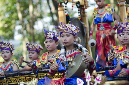 DENPASAR, BALI, INDONESIA - JUNE 18: Unidentified dancer of Balinese in colorful dresses variety on the parade at Bali Art Festival on June 18, 2014 in Denpasar, Indonesiaのeditorial素材