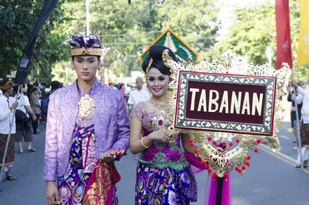 DENPASAR, BALI, INDONESIA - JUNE 18: Unidentified dancer of Balinese in colorful dresses variety on the parade at Bali Art Festival on June 18, 2014 in Denpasar, Indonesiaのeditorial素材