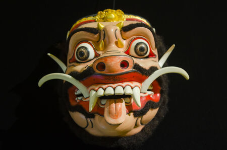 Traditional Balinese mask on a black background.の写真素材