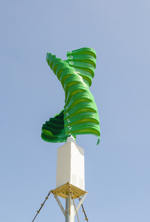Wind turbine in the vertical spiral shape against blue sky backgroundの写真素材