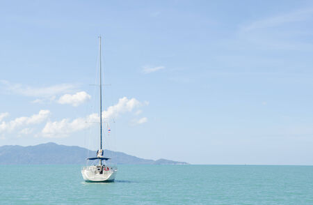 Sailing ship yachts with white sails in the open seaの写真素材
