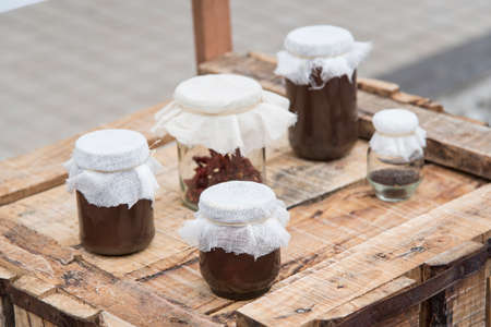 Chocolate dessert panna cotta in glass jars on wooden background