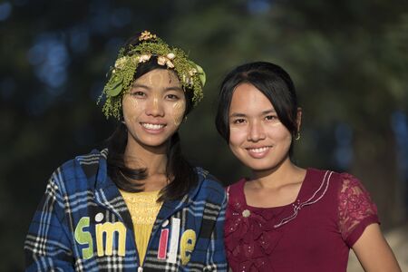 INWA,MYANMAR-October 12 : Myanmar woman with thanaka on her smile face is happiness on October 12,2015 in Inwa city,Middle of Myanmar.Thanaka is a yellowish-white cosmetic paste made from ground bark.のeditorial素材