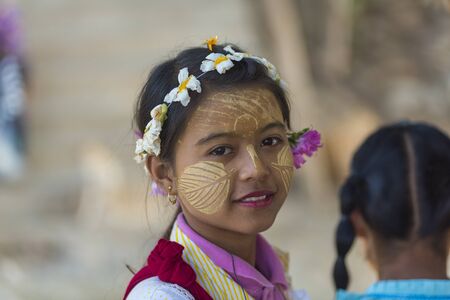 INWA,MYANMAR-October 12 : Myanmar woman with thanaka on her smile face is happiness on October 12,2015 in Inwa city,Middle of Myanmar.Thanaka is a yellowish-white cosmetic paste made from ground bark.のeditorial素材