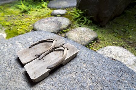 Onsen series : Two pair of wooden sandals on wooden floorの写真素材