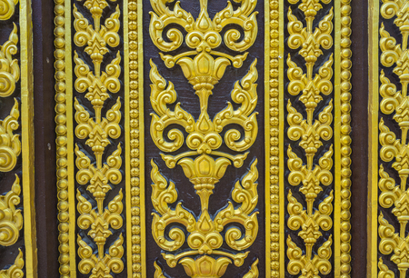 Temple door decorated with gold leaf designs Thailandの写真素材