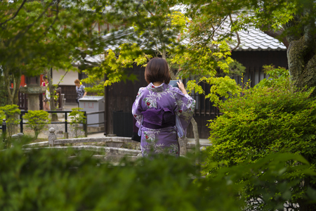 KYOTO, JAPAN - NOVEMBER 25 2015: Women tourism wear a traditional dress called Kimono for travelling in Kyoto on November 25 2015.のeditorial素材
