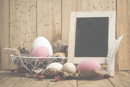 Easter concept with eggs on a wooden background, vintage filtered Imagesの写真素材