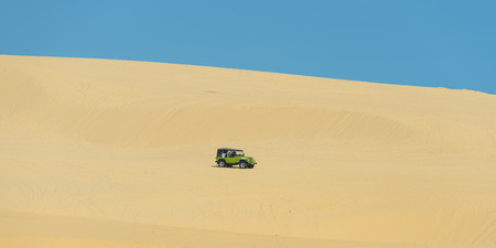 MUI NE - VIETNAM, JANUARY 18, 2016 : Tourists enjoy on the desert by jeep car in Mui ne, January 18, 2016のeditorial素材