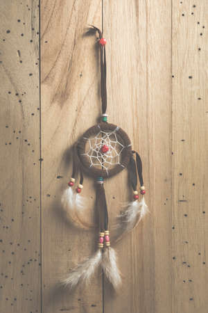 the dreamcatcher on wood background with sunlight, vintage filtered Imagesの写真素材