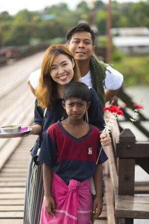 Sangkla Buri, Kanchanaburi, Thailand - November 19, 2016 : Little Mon people welcome tourists on the wooden bridge or Mon Bridgeのeditorial素材