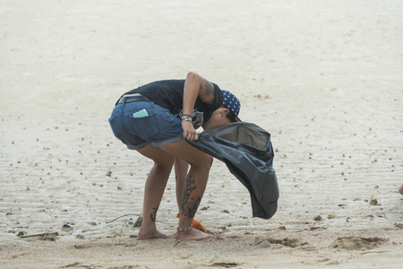 Phuket, THAILAND - JANUARY 4, 2017. Foreign tourists walk garbage on The beach in Phuket, Thailandのeditorial素材