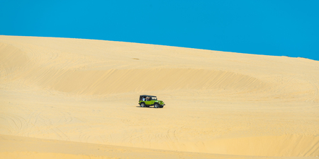 MUI NE - VIETNAM, JANUARY 14, 2017 : Tourists enjoy on the desert by jeep car in Mui ne, January 14, 2017のeditorial素材