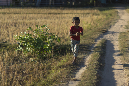 On March 8, 2017 Asian boy running in the local countrysideのeditorial素材