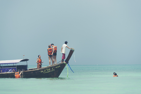 KRABI,THAILAND - April 14, 2017: Tourists enjoying the beautiful miracle beach & crystal clear water at Koh Kai, Koh Tub & Koh Mor, Krabi, Thaiandのeditorial素材