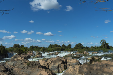 Tropical waterfall with blue sky in Laosの写真素材