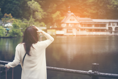 Asian girl tourists are happy by the lake in Fukuoka. Pic was taken in Oetober 2017.の写真素材
