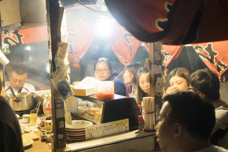FUKUOKA, JAPAN - OCTOBER 2, 2017: People eating Yatai mobile food stall at night in Fukuoka, Kyushu, Japanのeditorial素材