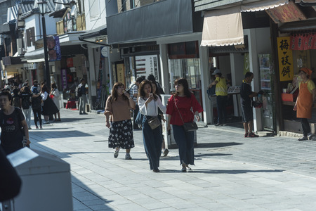 FUKUOKA,JAPAN-October 6, 2017: Many Tourists are walking pass the Torii gate of Dazaifu tenmangu shrine ,The most famous and ancient in Fukuoka, Japanのeditorial素材